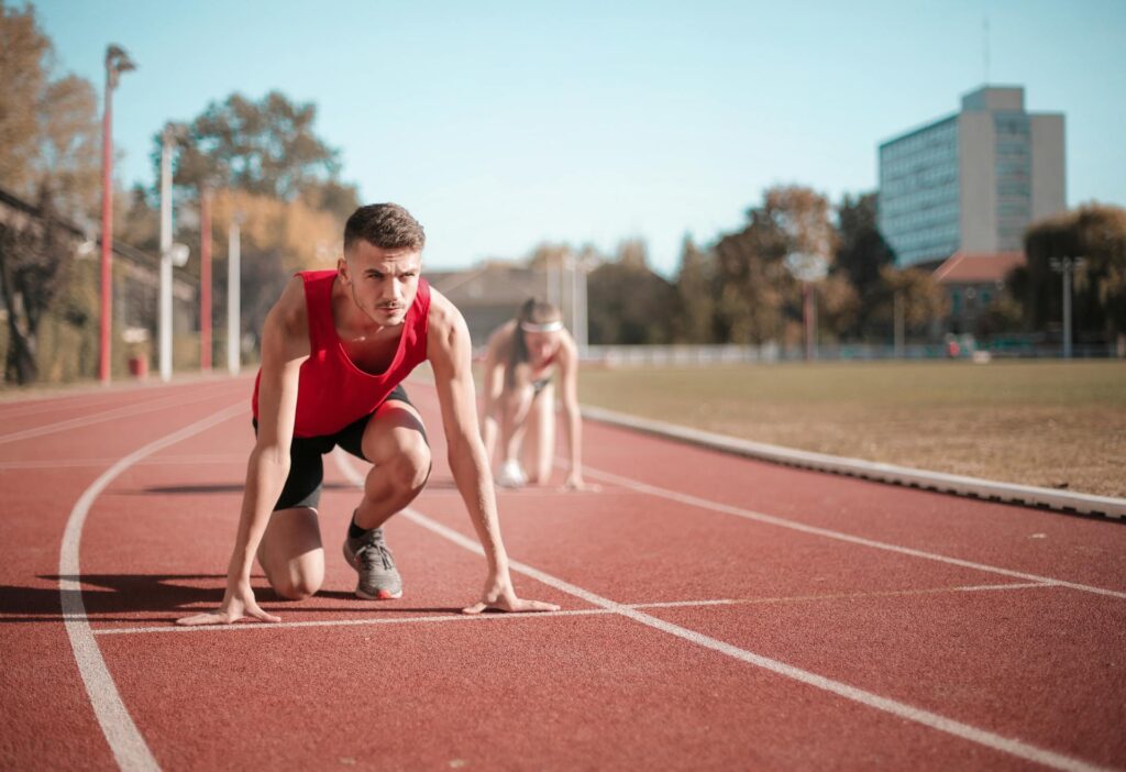 Athletic runner in starting blocks on outdoor track, ready to sprint, symbolizing a strong kickstart to 2026 with healthy habits and chiropractic wellness at ChiroCure Health Center